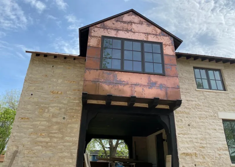 Copper metal panel facade on a stone building for Skylight Installation in Silver Springs